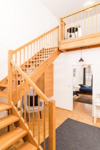 a staircase in a house with a living room at Cozy Kunsthaus GRAZ in Graz