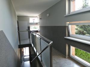 a staircase in a house with two windows at Pokoje Gościnne z Prywatną Łazienką dla firm in Gliwice