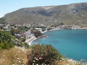 a view of a beach with a town and mountains at Irene's Studio in Kalymnos