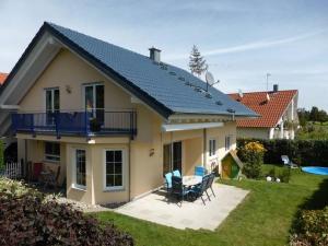 a house with a solar roof on top of it at Ferienwohnung Bruttel in Gaienhofen