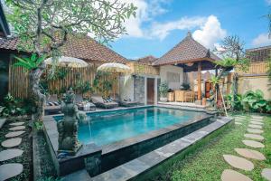 a swimming pool in the backyard of a house at Sitala Suite in Ubud