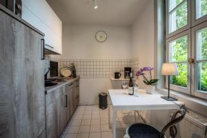 a kitchen with a white counter and a table at Ferienwohnung am Dom in Naumburg