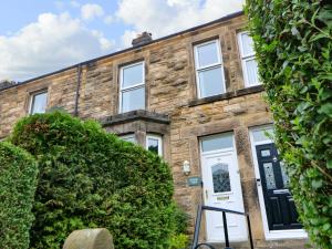 a brick house with a white door and windows at Stang View in Barnard Castle