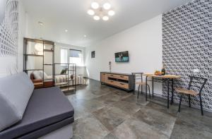 a living room with a couch and a table at Теремки in Kyiv