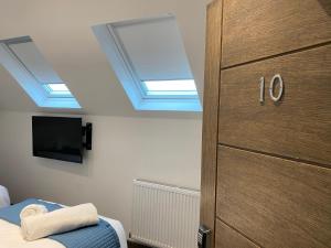 a bedroom with a ceiling with skylights and a closet at The Arc Hotel in Liverpool
