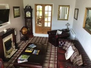 a living room with a couch and a fireplace at Montague Villa in Dunoon