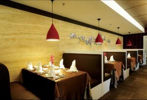 a dining room with tables and red lights at Kings Green Hotel City Centre Melaka in Melaka +88 photos