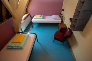 a small room with a bed and a chair at Strowis Hostel in Utrecht