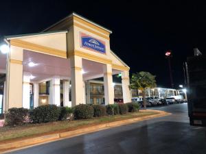 a building with a sign on the side of it at Howard Johnson by Wyndham Perry GA in Perry