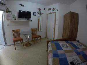 a bedroom with a bed and a table and chairs at The Taras unit in Eilat