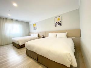 Voodi või voodid majutusasutuse Fengjia JinRui Hotel toas
