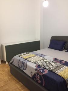a bedroom with a bed with a quilt on it at Patision Avenue, Apartment with Two bedrooms in Athens