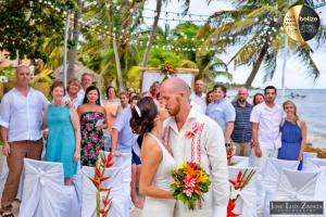 a bride and groom kissing at their wedding ceremony on the beach at Portofino Beach Resort-An Authentic Island Escape! in San Pedro