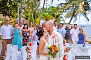 a bride and groom kissing at their wedding ceremony on the beach at Portofino Beach Resort in San Pedro