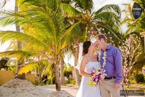 a bride and groom kissing in front of a palm tree at Portofino Beach Resort-An Authentic Island Escape! in San Pedro