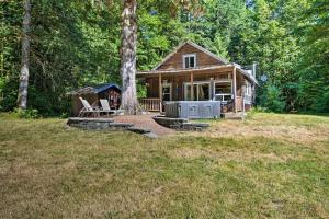 a log cabin with a porch and a tree at Mysty Mountain Cabin on River 15Mi to Stevens Pass in Skykomish