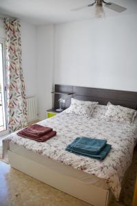 a bedroom with a bed with two towels on it at Guejar Sierra House with Spectacular Views in Güéjar-Sierra