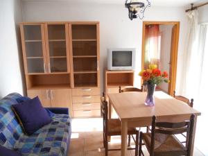 a living room with a table with a vase of flowers at Gites-Sassone in Sagone