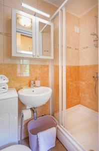 a bathroom with a sink and a toilet and a shower at Apartment Dubrovnik in Dubrovnik +6 photos