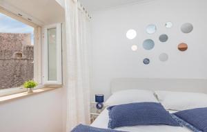 a white bedroom with a bed and a window at Apartment Dubrovnik in Dubrovnik
