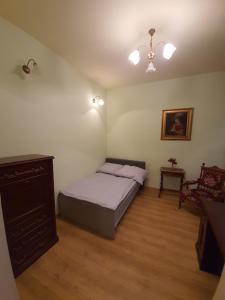 a bedroom with a bed and a dresser in it at Willa Widok in Nałęczów +10 photos