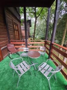 a group of chairs and a table on a porch at Willa Widok in Nałęczów