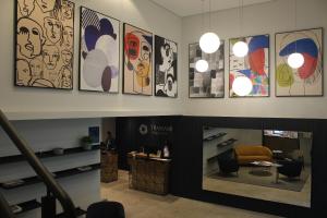 a lobby of a store with paintings on the wall at Transamerica Executive Bela Cintra (Paulista) in São Paulo