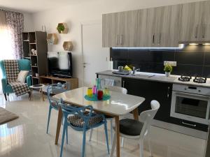a kitchen and living room with a table and chairs at Tatli Apartment in Famagusta