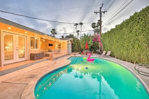 a swimming pool in the backyard of a house at Palm Desert Abode Pool, Walk to El Paseo District in Palm Desert