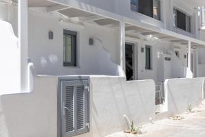 a white house with a door on the side of it at Marina's Suites in Naxos Chora