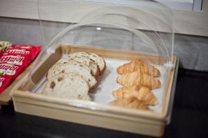 a plastic container filled with bread and other food at Ari House in Seoul