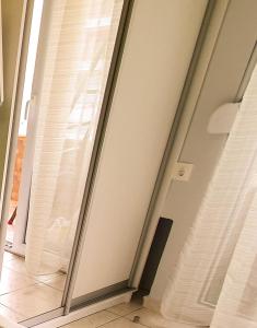 a sliding glass door in a room with a window at Apollo 2 - Luxury Apartment in Katerini