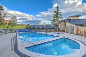 a large swimming pool in a courtyard with a building at Torian Plum Creekside II in Steamboat Springs