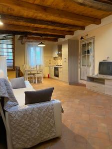 sala de estar con sofá y TV en Le Casette nel Borgo, en Pitigliano