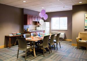 a dining room with a table and chairs and a balloon at Timberlake Lodge in Grand Rapids