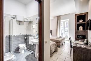 a bathroom with a sink and a toilet and a shower at Napoli Suite in Naples +39 photos