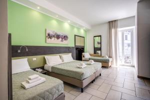 Posteľ alebo postele v izbe v ubytovaní Napoli Suite