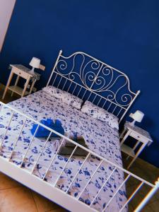 サルテアーノにあるClaves Claustri - Appartamento storico con balconeの青いベッドルーム(ベッド1台、テーブル2台付)
