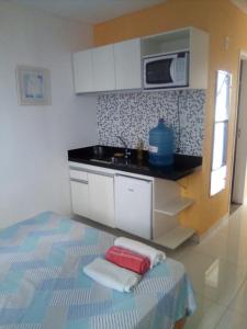 a kitchen with a sink and a microwave at Silva Hospedagem in São Luís