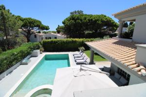 a villa with a swimming pool and a house at Charming Exceptional Golf Villa in Algarve in Faro