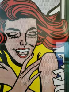 a mural of a woman holding a mirror at La casa gentile appartamento Aurora in Roccaverano