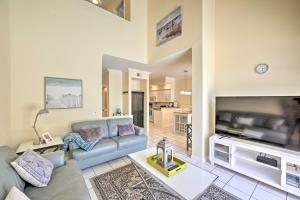a living room with a couch and a tv at Cape Coral Escape with Screened Pool, Near Beaches! in Cape Coral