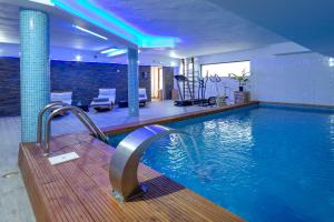 a large swimming pool in a building with a swimming pool at Les Pins Blancs en Provence in Le Muy