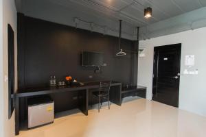 cocina negra con escritorio y silla en B-Black Hotel Chonburi, en Chonburi