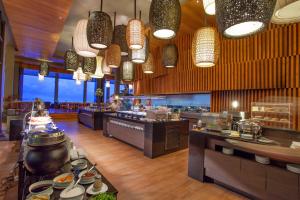 a restaurant with a large kitchen with a buffet at Cape Dara Resort - SHA Plus in North Pattaya