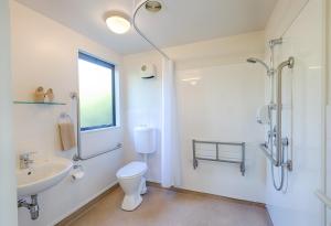 a bathroom with a sink and a toilet and a shower at Bella Vista Taupo in Taupo +21 photos