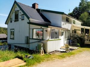 a house that is sitting in the grass at Lägenhet naturnära i Henån in Henån