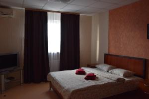Postel nebo postele na pokoji v ubytování Voskhod Hotel
