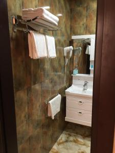 a bathroom with a sink and a mirror at Hirkan Park Hotel in Lankaran