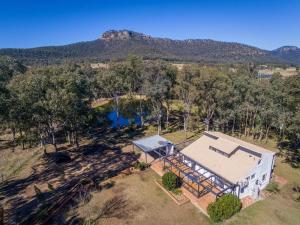 an aerial view of a house with a mountain in the background at Marlu Station in Broke